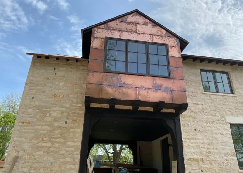 Copper metal panel facade on a stone building for Skylight Installation in Wheatfield